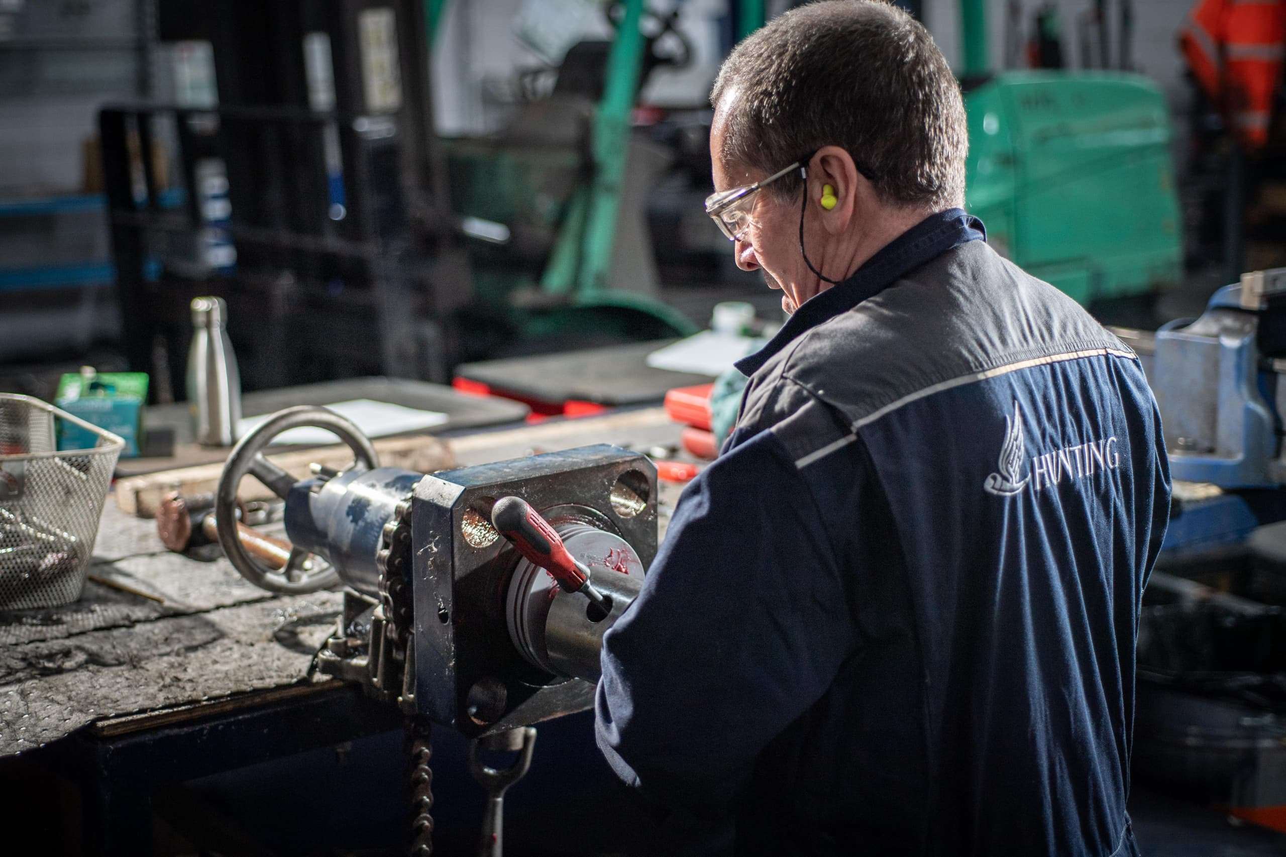 Person with Hunting logo on back in a workshop