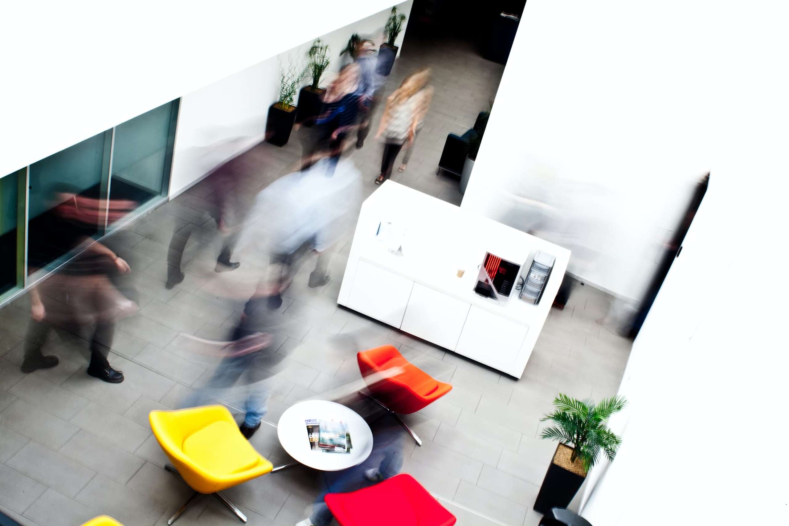 Long exposure of people walking through an office
