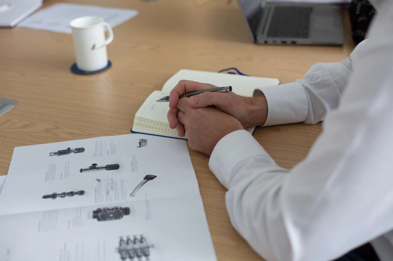 Person in white shirt taking notes