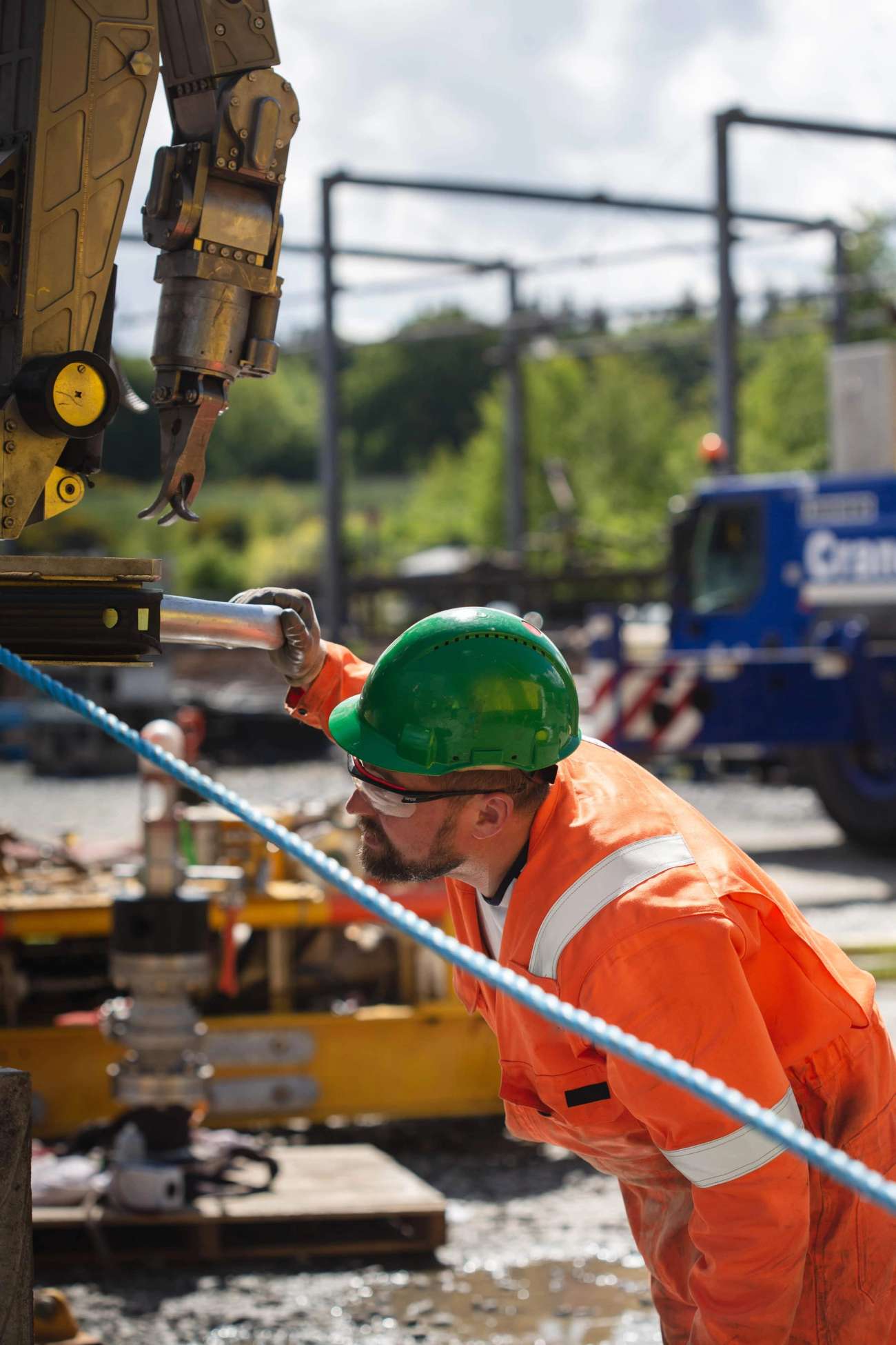 Person in boiler suit working on machinery in yard