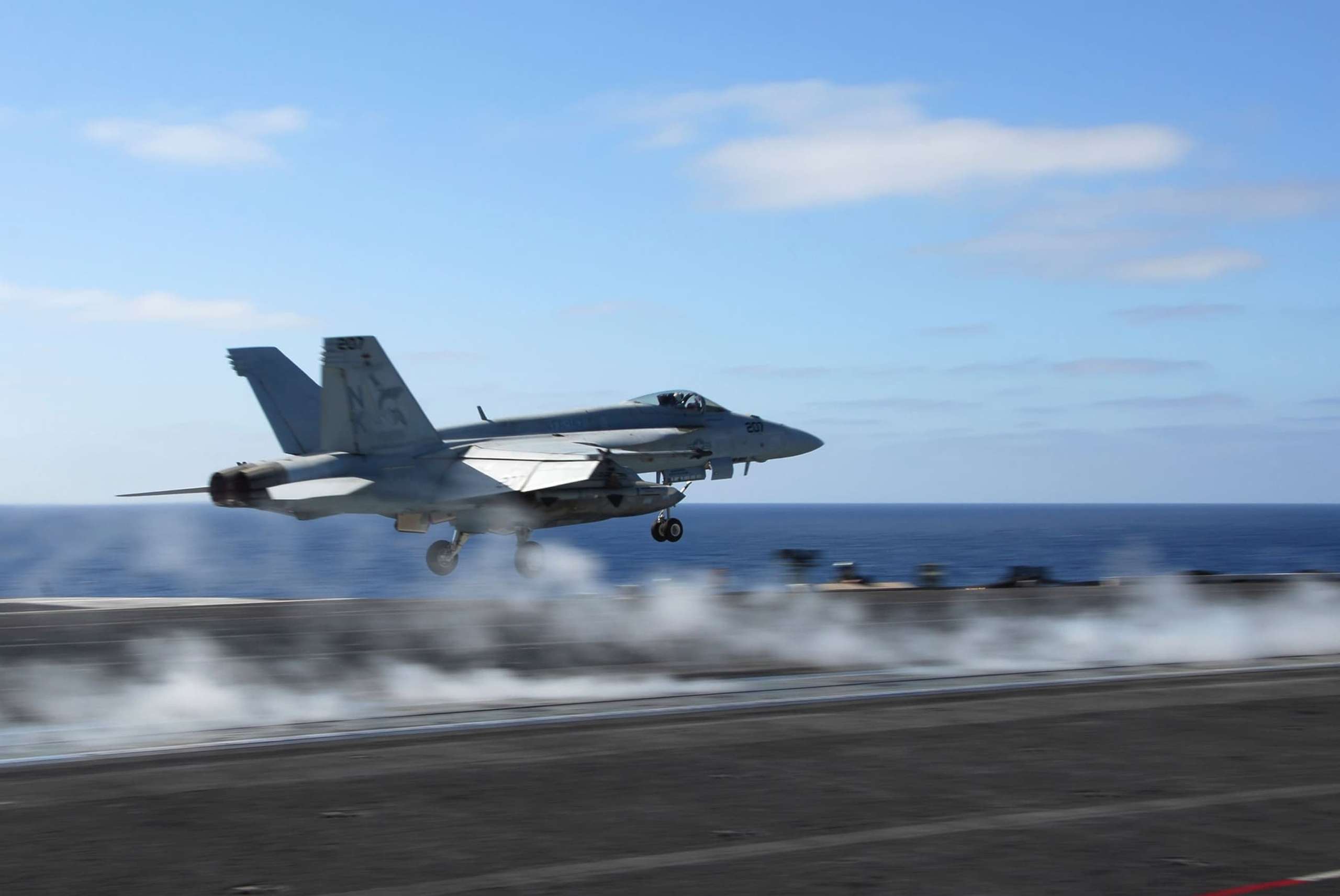 Fighter jet taking off from aircraft carrier