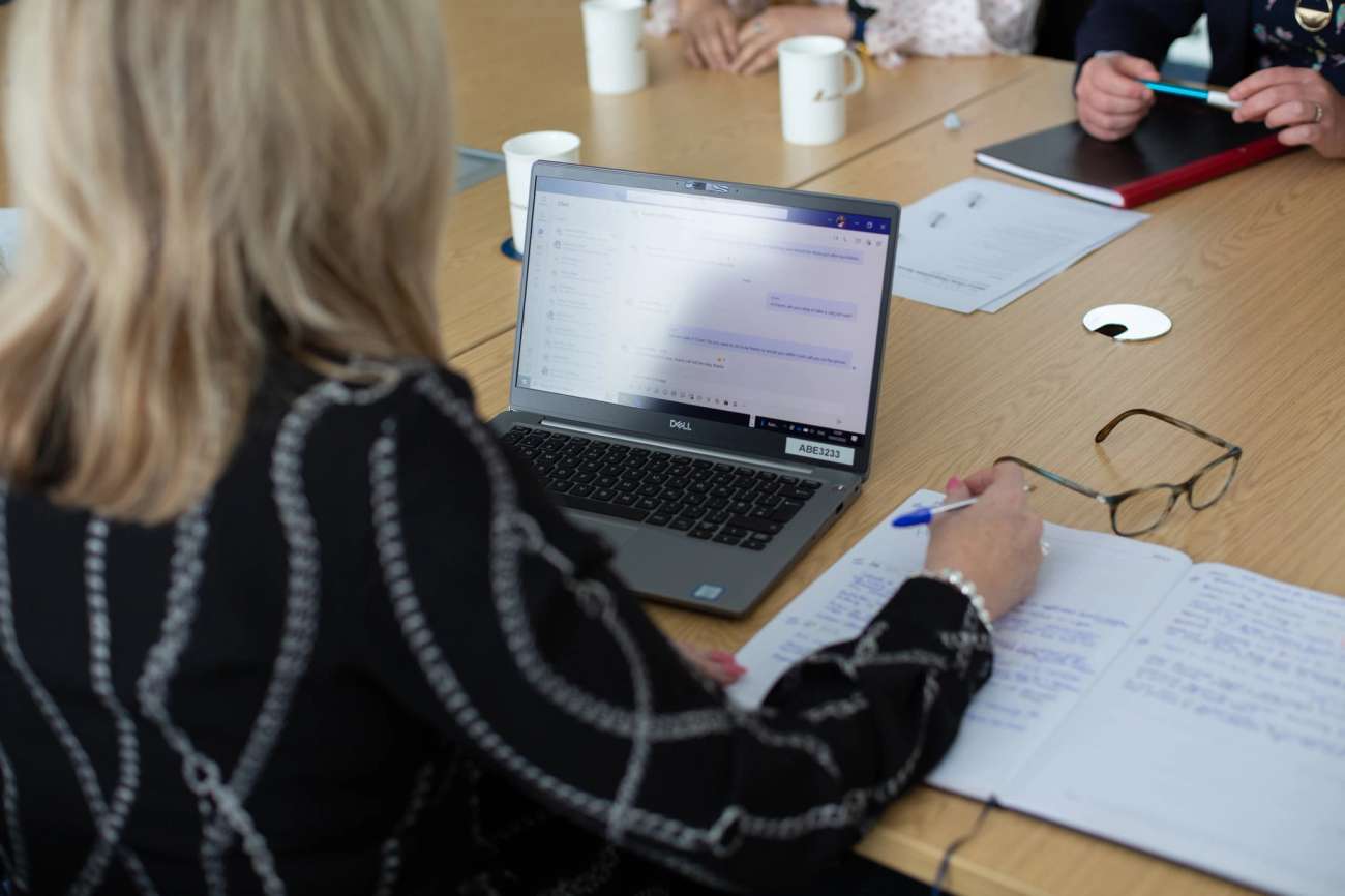 Person on laptop taking notes