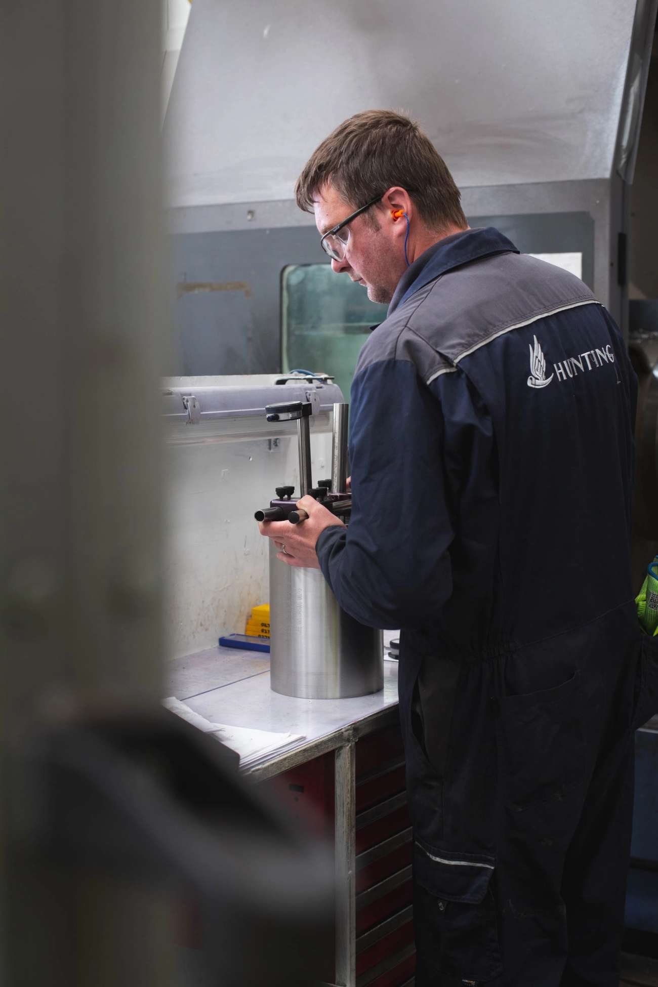 Person in Hunting overall testing a tubular device