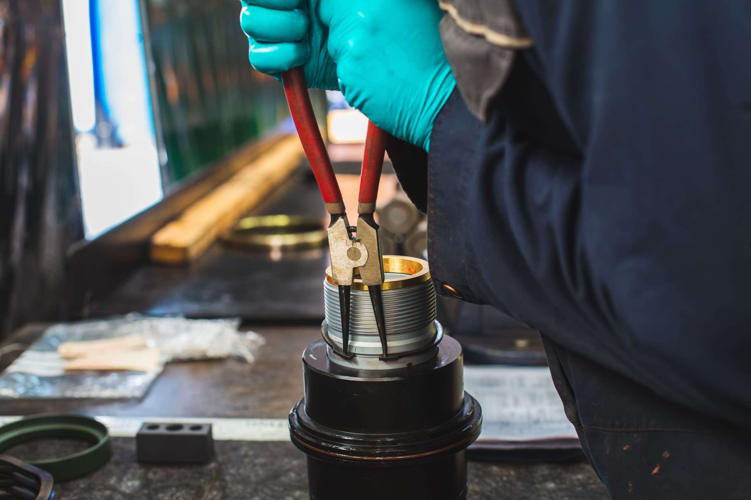 Person working with a plyer on a tool